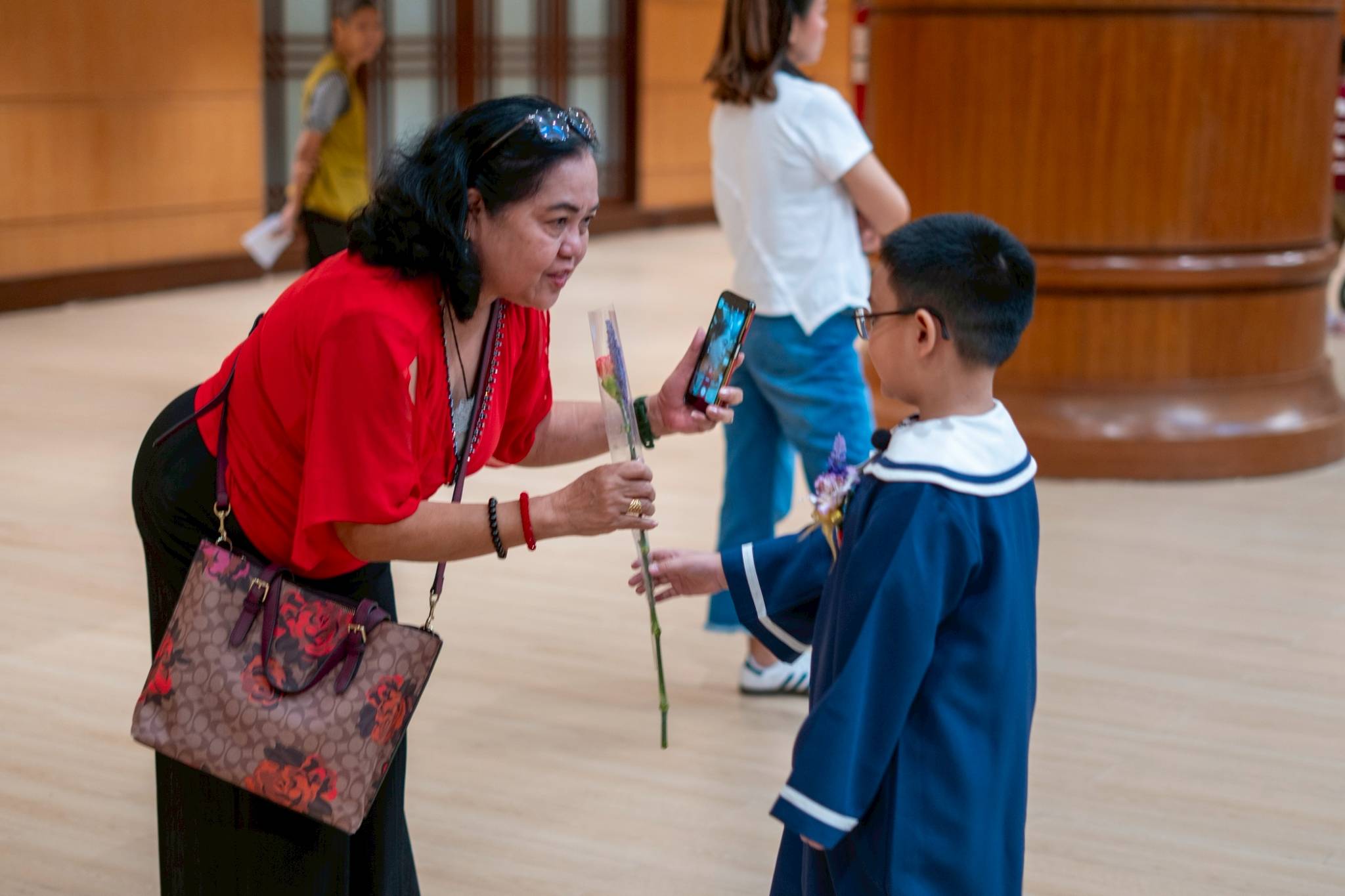 As a sign of their love and respect, students surprise their parents with long-stemmed roses.