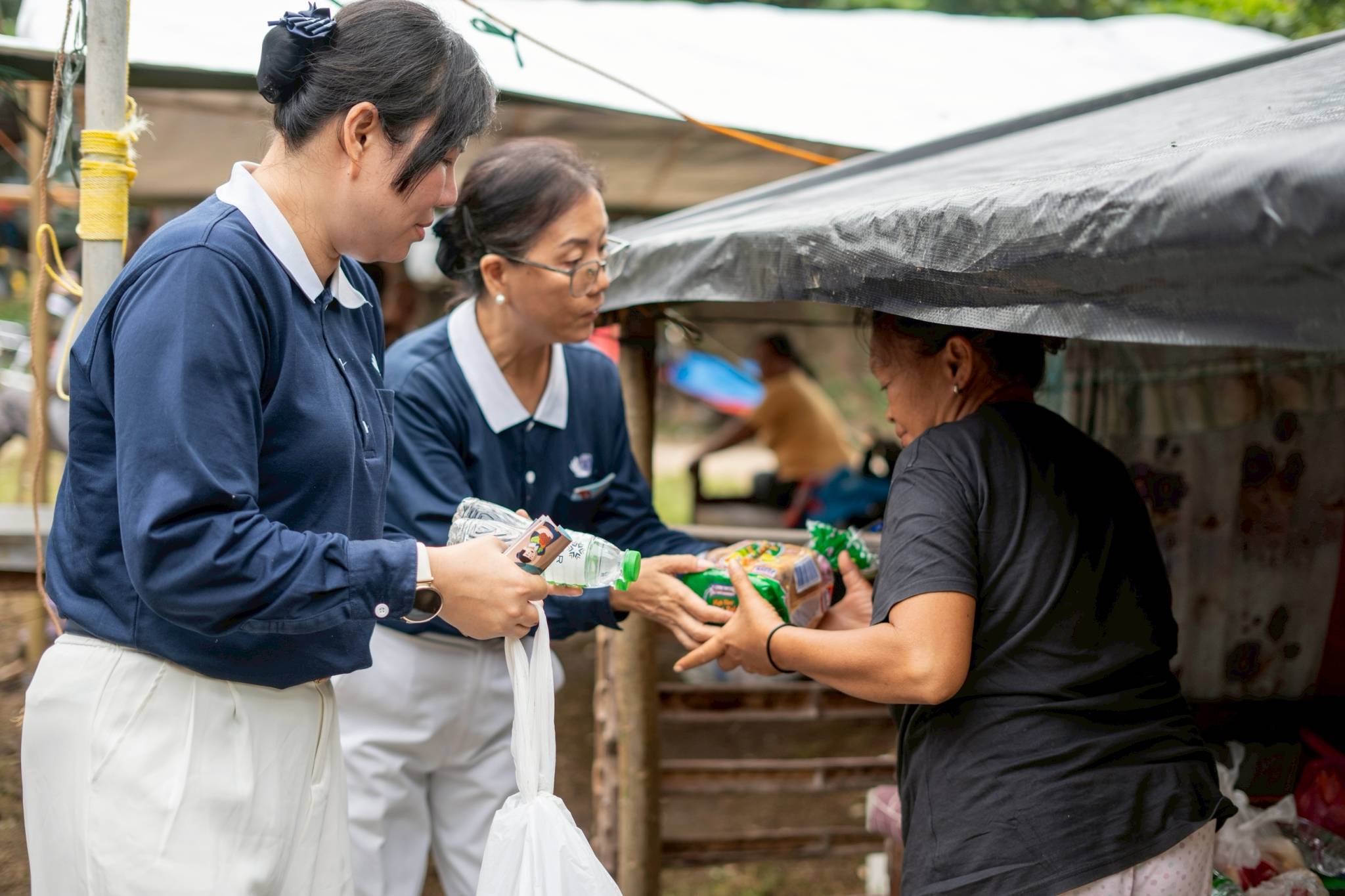 A resident accepts bread and water offered by Tzu Chi volunteers. 