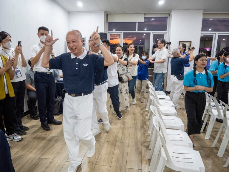 Attendees of the thanksgiving party happily join in “Pulling the Ox Cart”.