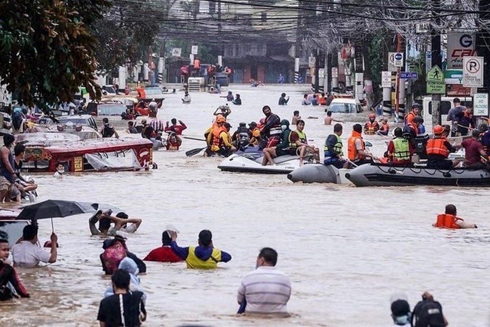 Residents negotiate the chest-high flooded streets and homes in Marikina City during the height of Typhoon Ulysses in 2020. 