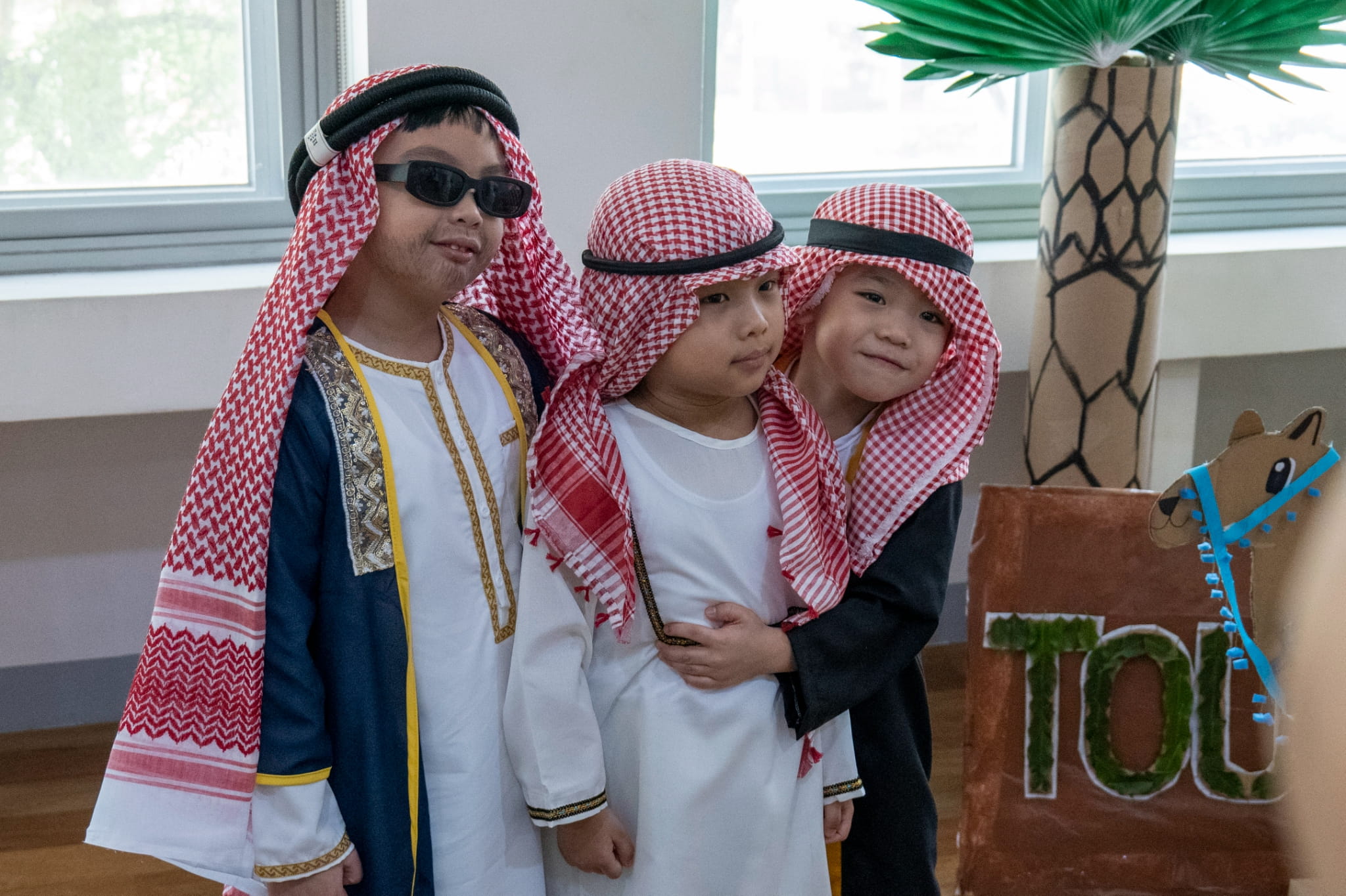 The kindergarten boys proudly wear thobes, a traditional garment worn in Arab countries.