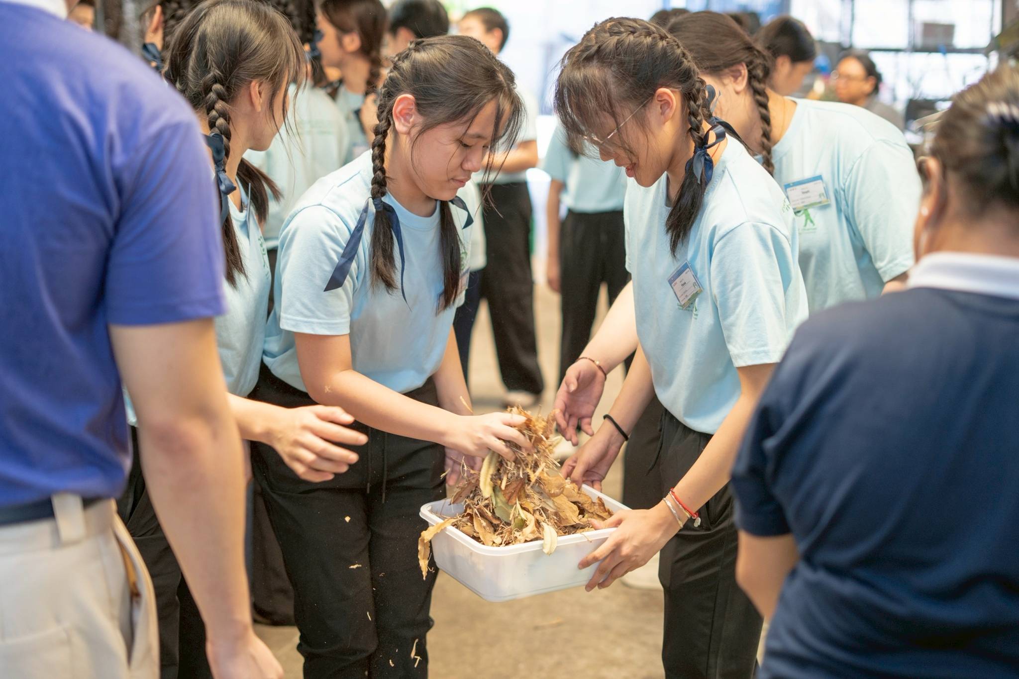 Campers learn how to compost by layering “browns” (cardboard, dried leaves) and “greens” (kitchen scraps, garden waste) to enrich the soil. 