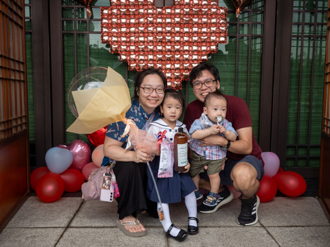 Families pose for photos at the kiddie market photo booth.