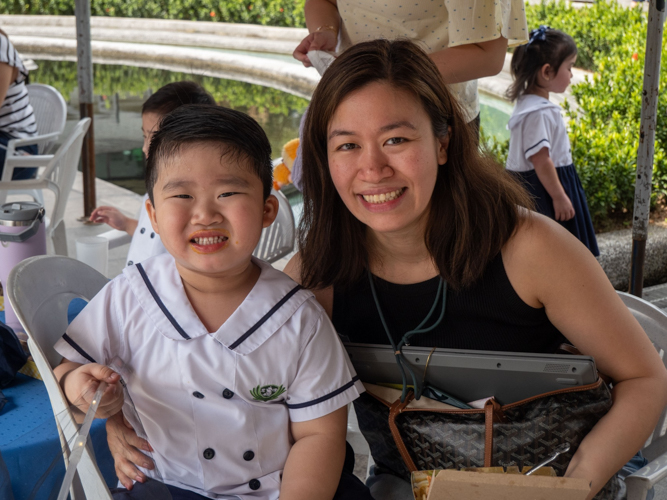 The cheery mother-and-son duo pose for a photo at the kiddie market.