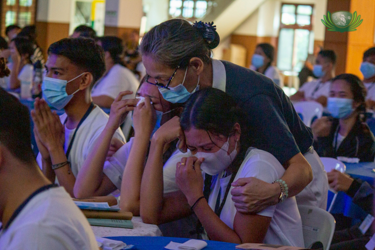 Scholars get a hug from a volunteer as they turn emotional writing a letter to their parents. 