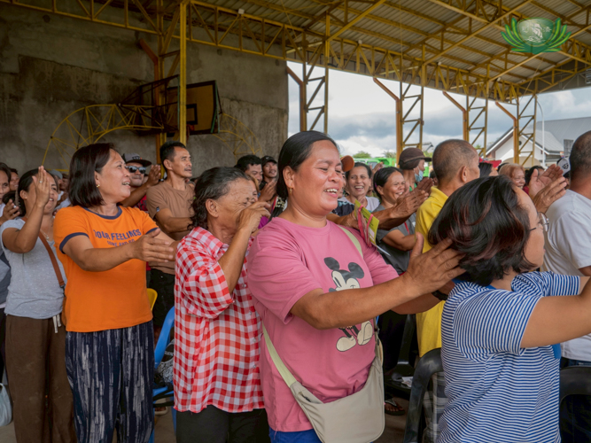 Beneficiaries share a light moment as they take part in a fun massage activity.