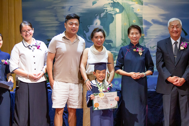 Flanked by Tzu Chi commissioners and special guests, parents pose proudly with their kids in the second moving up ceremony of Tzu Chi Great Love Preschool Philippines.