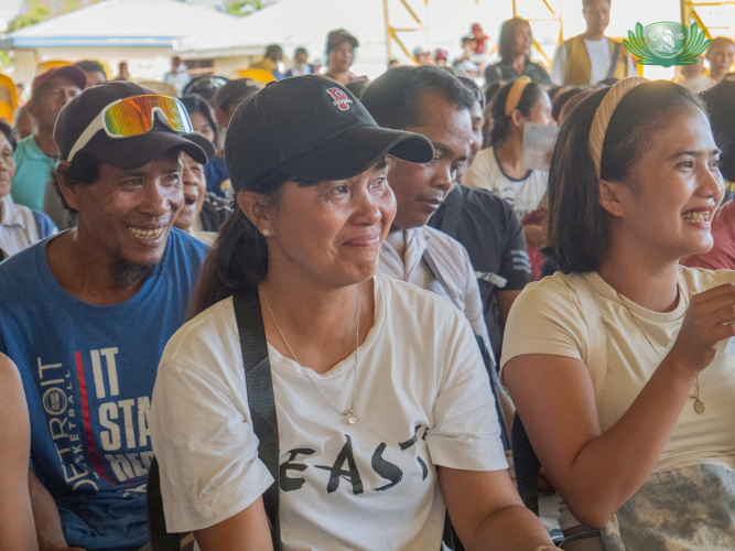A beneficiary sheds tears as she learns about the financial assistance she will receive to help her recover from the consecutive typhoons.