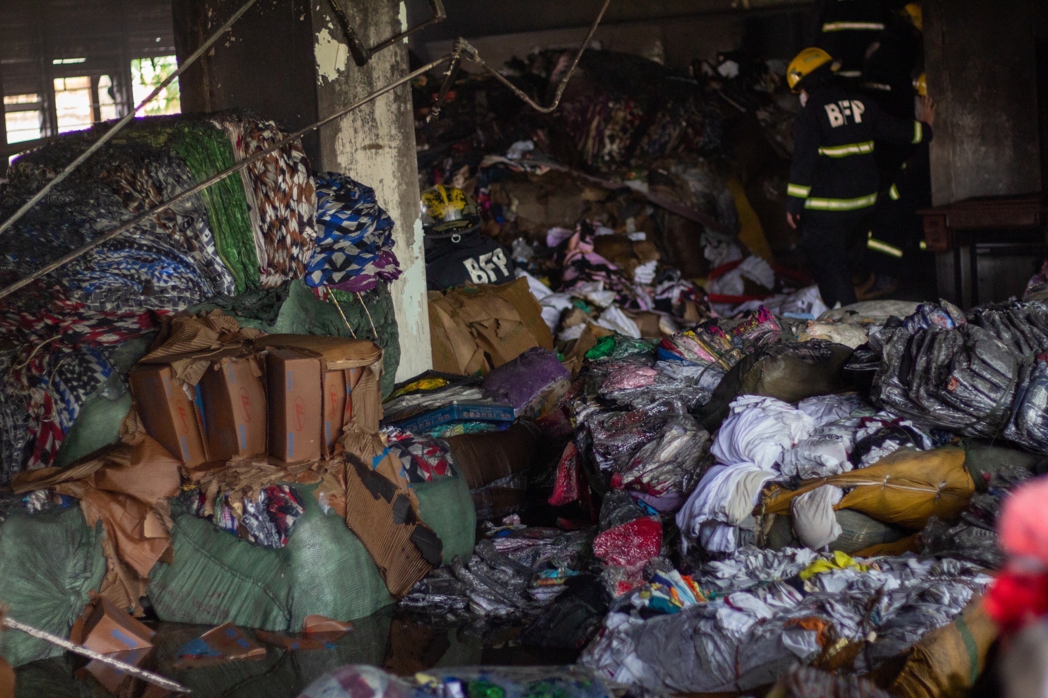 Firefighters inspecting the remains of the building. 【Photo by Harold Alzaga】