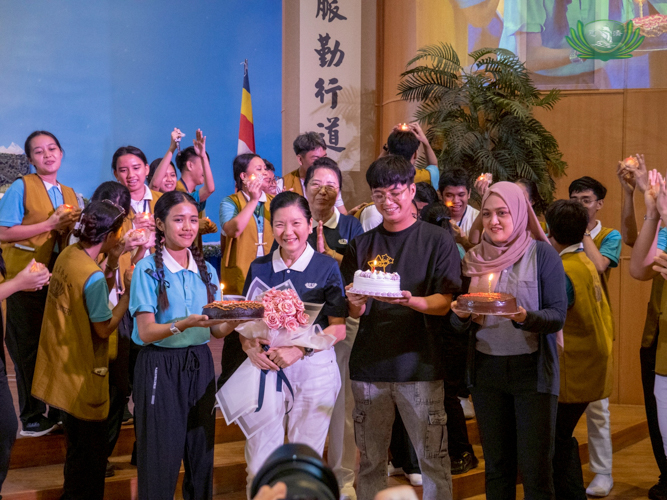 At the Jing Si Auditorium, Tzu Chi Education Committee Head Rosa So (second from left) gets birthday cakes from camp head Cristine Mae Udarbe, former Charity Department staffer Joseph Ian Manlulu, and Charity Department Social Welfare Officer Almalyn Dinampo.