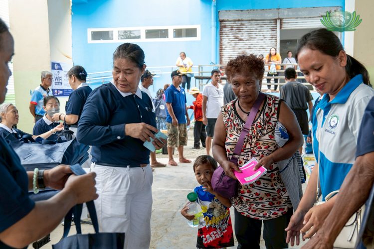Josephine Perater, 53, from Sitio Iyapit, Umiray, Dingalan (with child), waits for her turn to receive assistance. She is a member of the Dumagat Indigenous People.