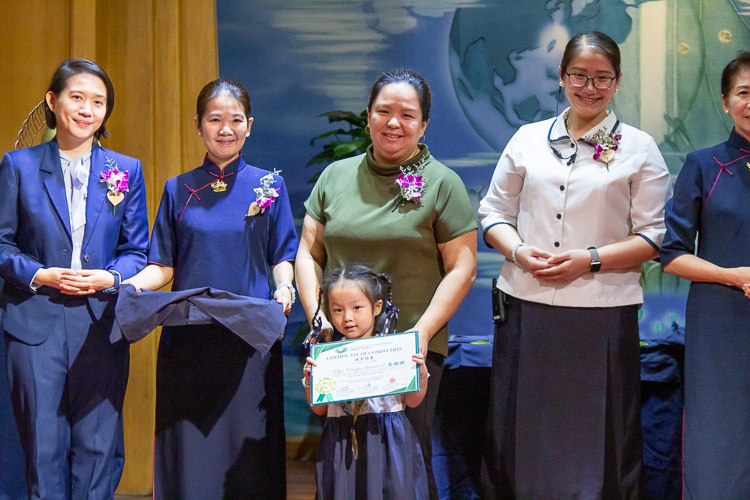 Flanked by Tzu Chi commissioners and special guests, parents pose proudly with their kids in the second moving up ceremony of Tzu Chi Great Love Preschool Philippines.