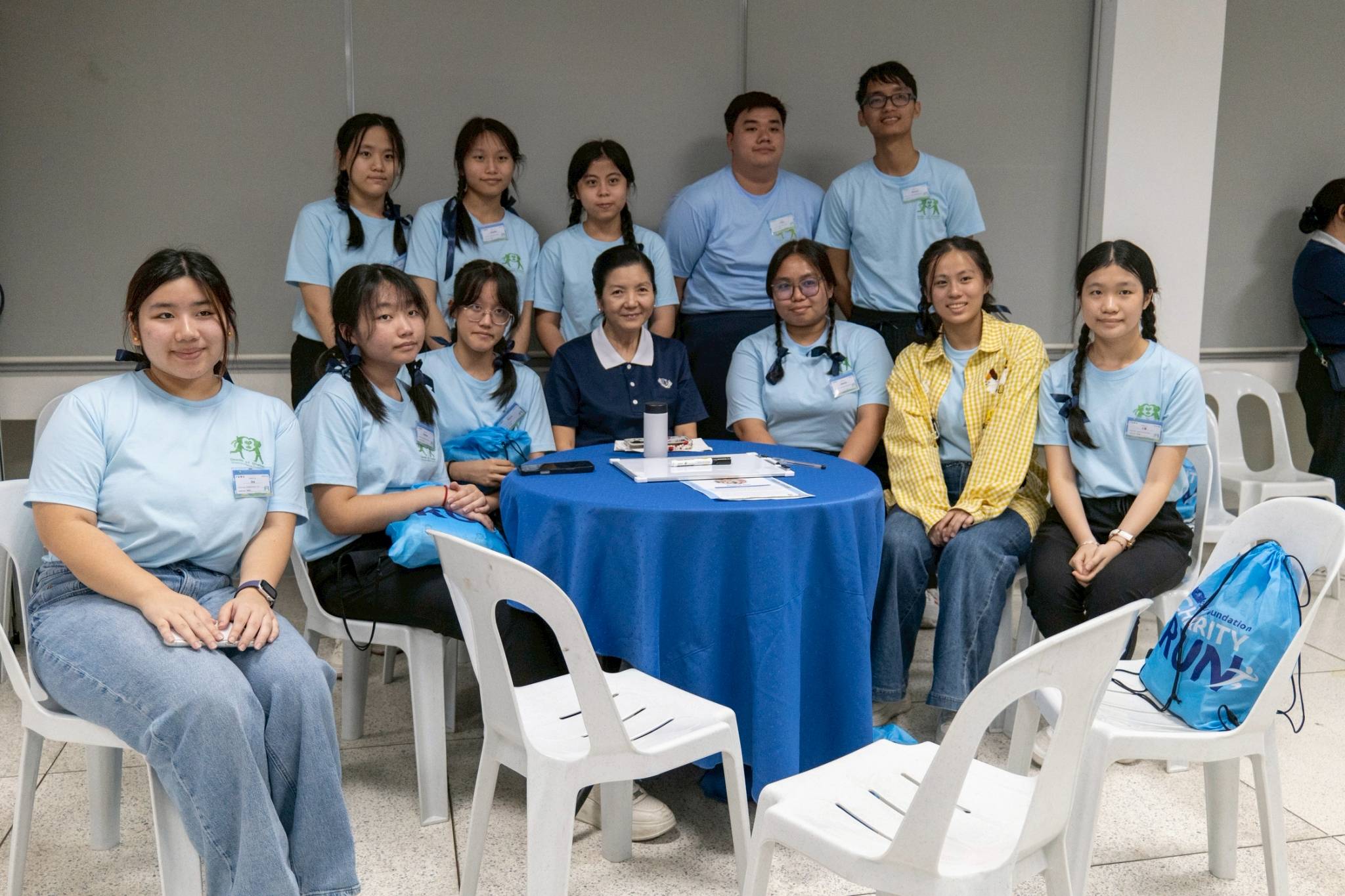 Tzu Chi Education Committee Head Rosa So (seated, center) poses with campers after her sharing on how she became a Tzu Chi volunteer. 