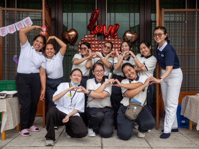 Teachers, volunteers, and staff pose for a fun photo after the successful kiddie market event.