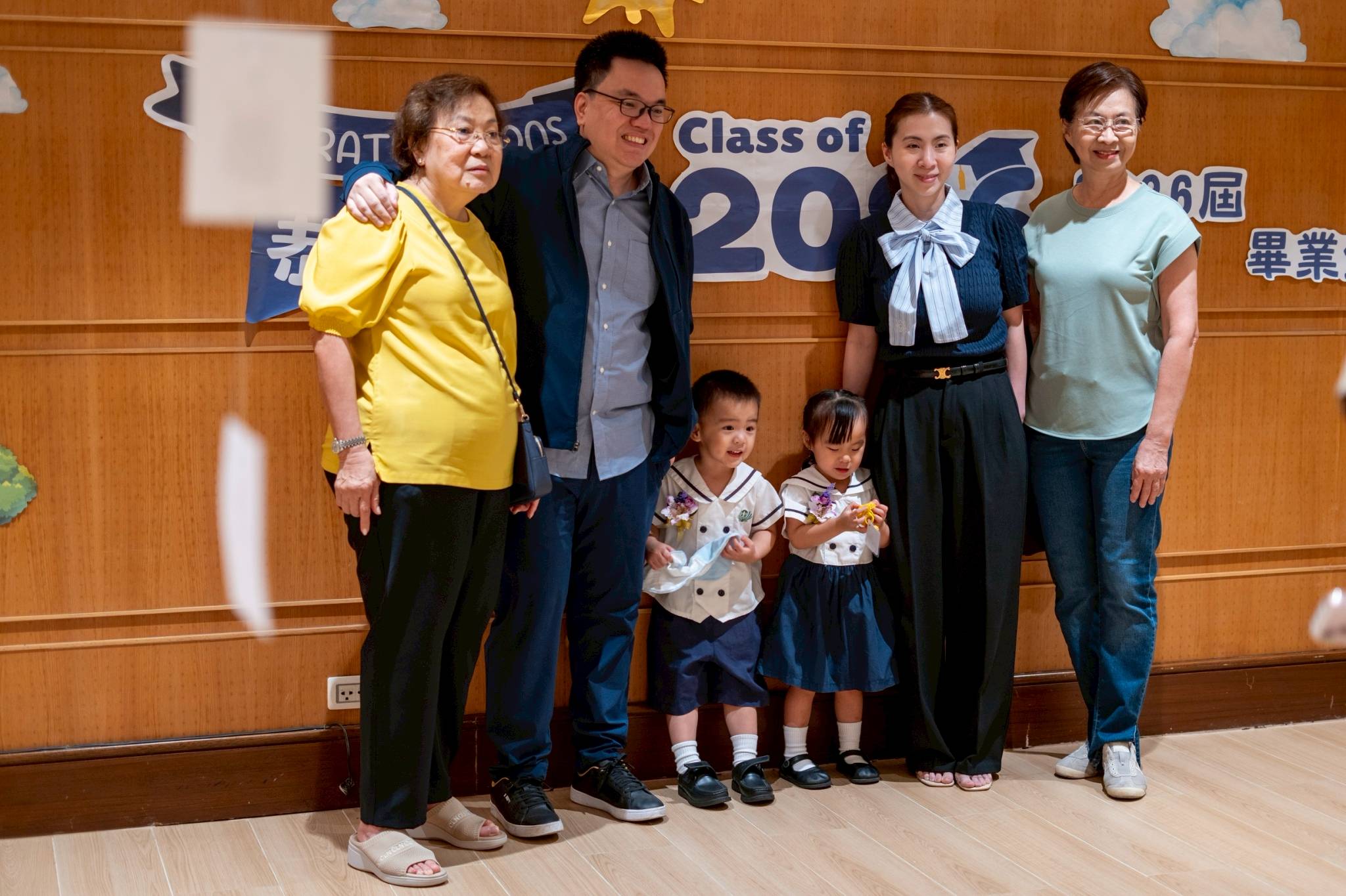 Families pose for pictures before the start of the Moving Up Ceremony.