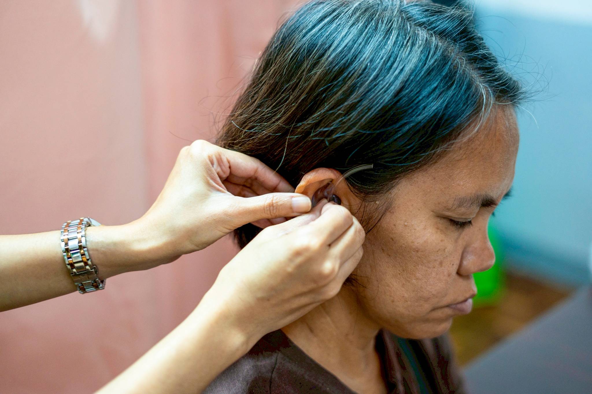 Her hearing aid is regularly checked to ensure it fits properly and meets her hearing needs.