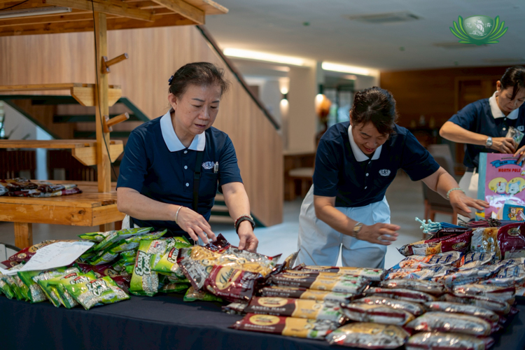 At the Unity Hall, volunteers arrange dry goods before shoppers arrive.