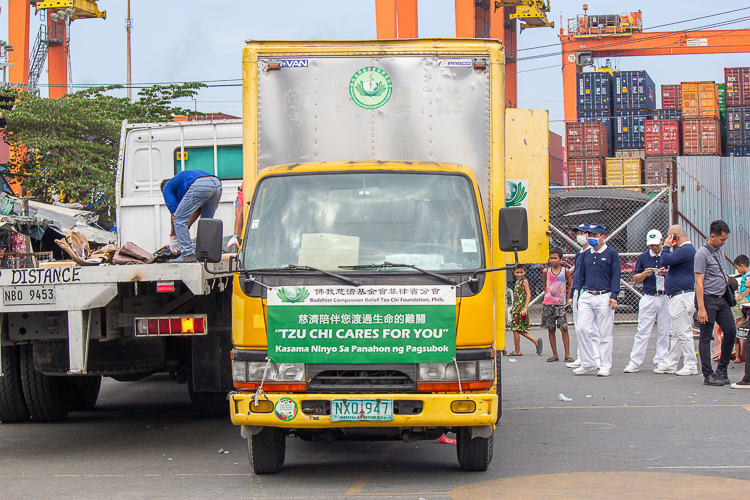 Tzu Chi volunteers pack up after a successful day of distributing GI sheets to families in need. 【Photo by Marella Saldonido】