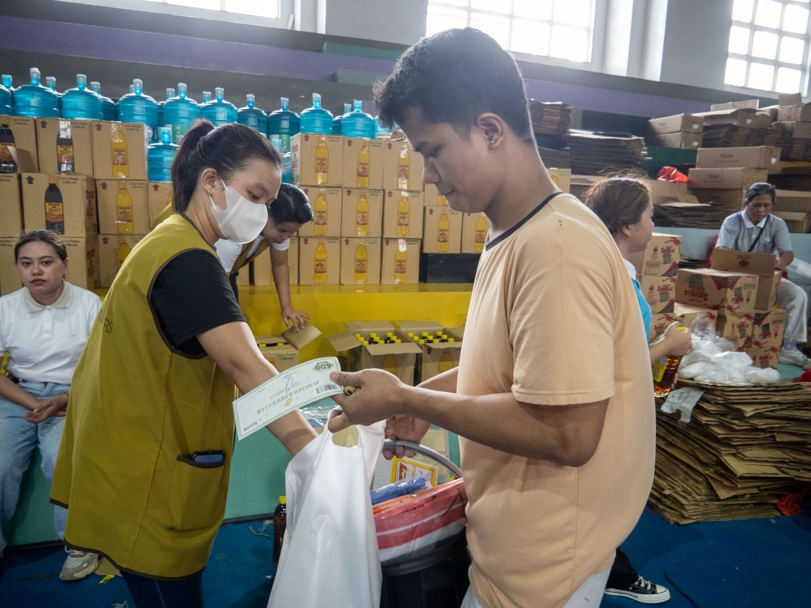A beneficiary receives essential home items and a gift voucher.