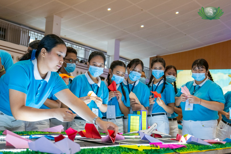 After writing their vows on their paper planes, scholars place them on a symbolic runway. 