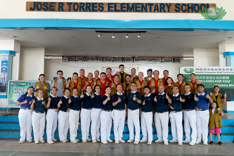 Tzu Chi volunteers take a photo with fellow volunteers from PCCCI after a successful relief distribution.