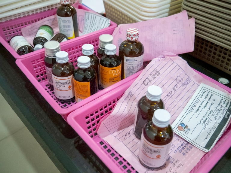 Patients received free medicines after consultations, with orderly queues observed at the pharmacy.