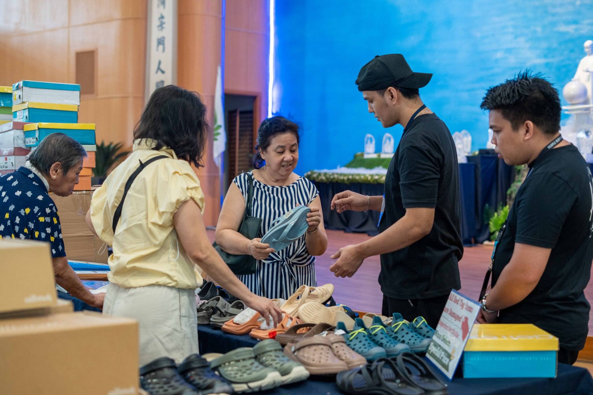 Enthusiastic shoppers explore a selection of high-quality sandals from trusted brands like Allbirds, Birkenstock, Aetrex, and more.