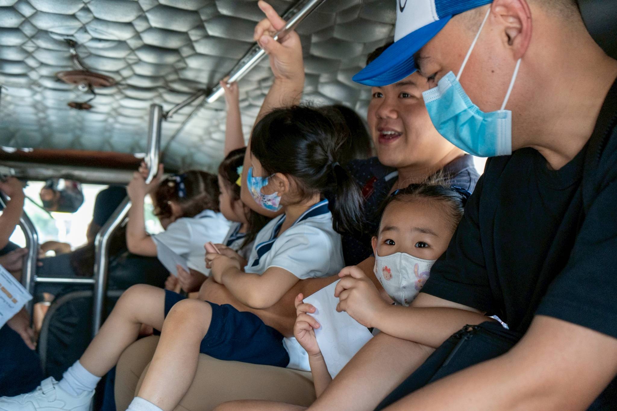 The children took extra precautions by holding the handrails throughout the ride.