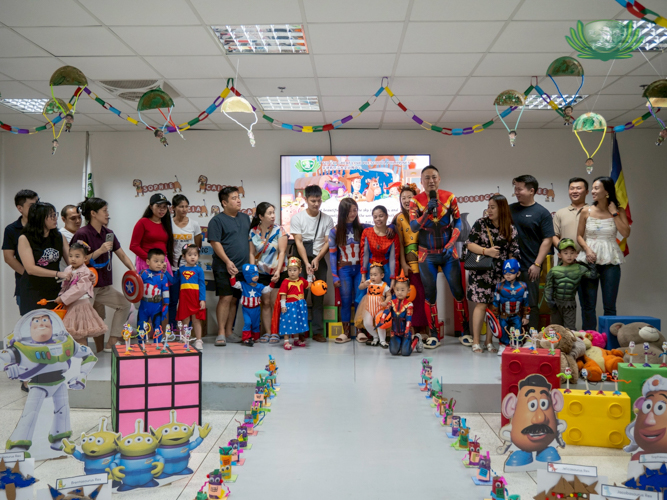 Parents and their kids dress as their favorite Marvel and DC comics characters in the “Superheroes” station.