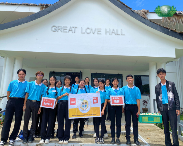 Scholars pose together for a photo as they start selling their eco-enzyme dishwashing soap.