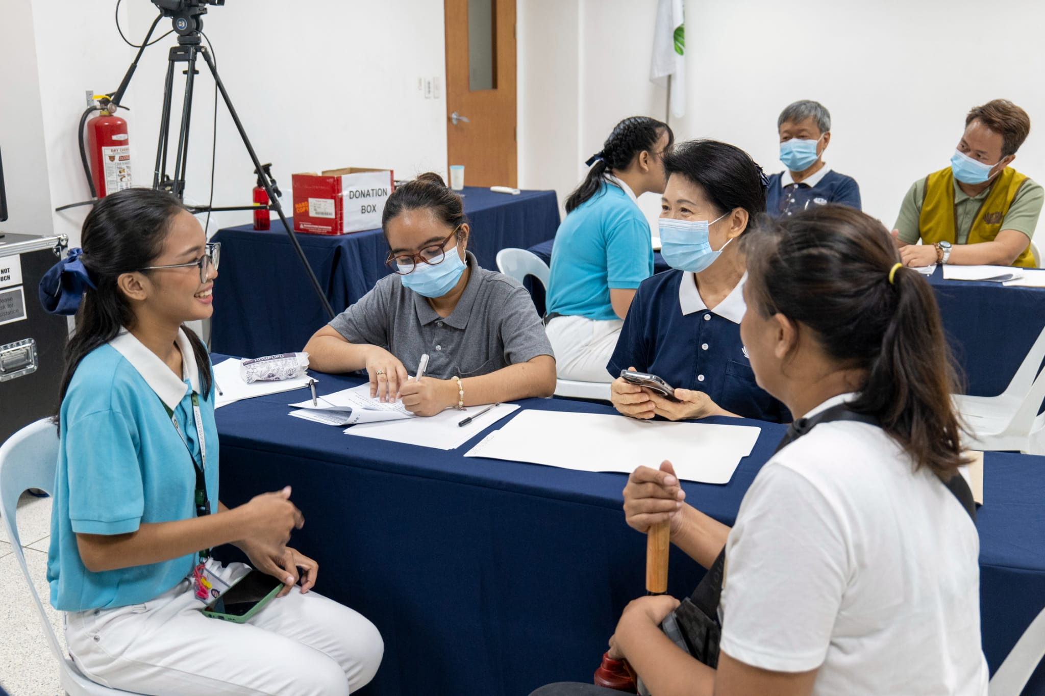 Tzu Chi scholar Zara Vladislav Javier (left) explains her transformation from a timid student to a more vocal one to Tzu Chi Deputy CEO Woon Ng (second from right). A Tzu Chi scholar from Grade 6 to 10 at Lakan Dula High School, she is now enrolled in senior high at St. Jude College. 