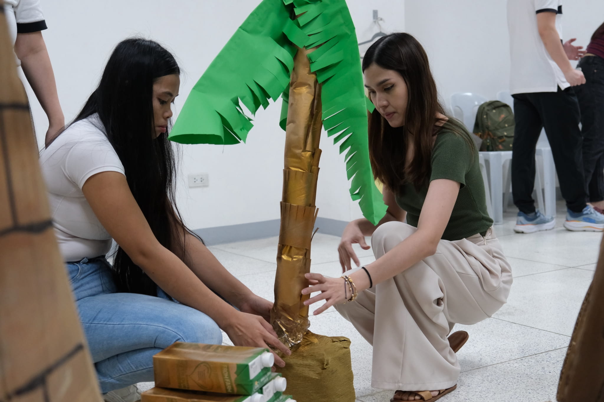 Parents work together behind the scenes to prepare their cultural booths. 