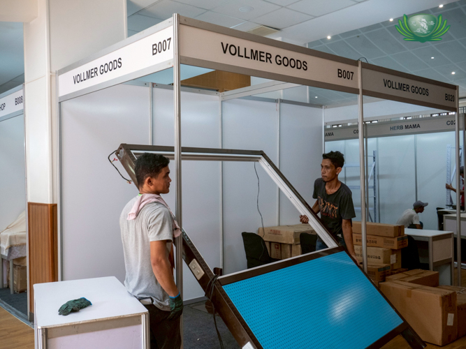 At the Jing Si Auditorium, workers assemble exhibitor booths. 