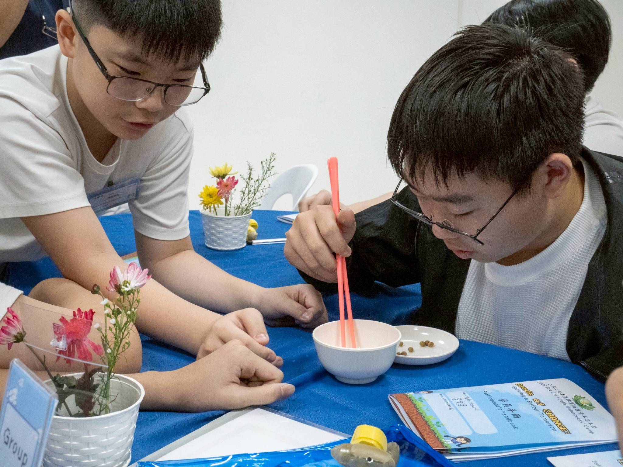 Young campers practice their chopstick skills. 