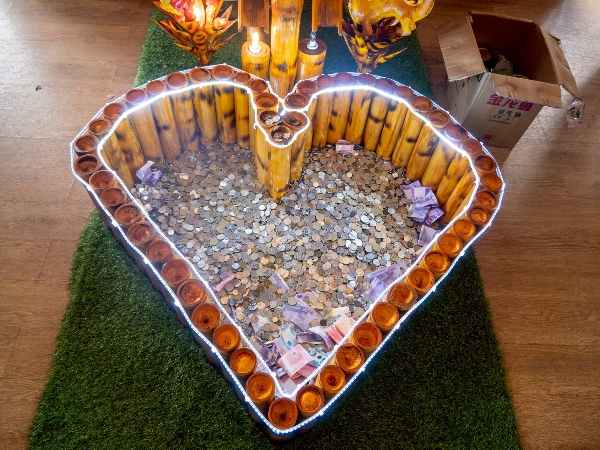 Donations are pooled in a heart-shaped bamboo receptacle. 