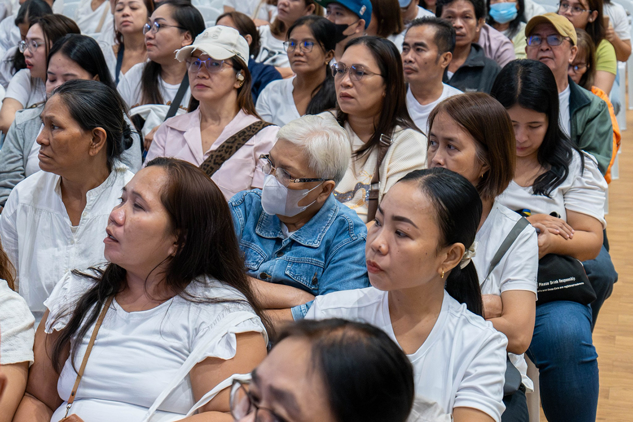 Salve Bustamante (in denim jacket) listens attentively to  the terms of the scholarship contract with Tzu Chi. 