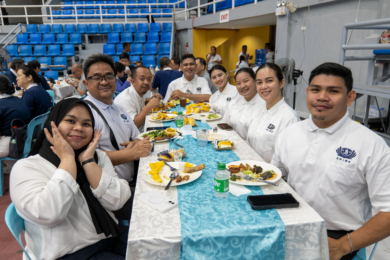 A quick pause from their meal: volunteer TIMA doctors share a smile for the camera.