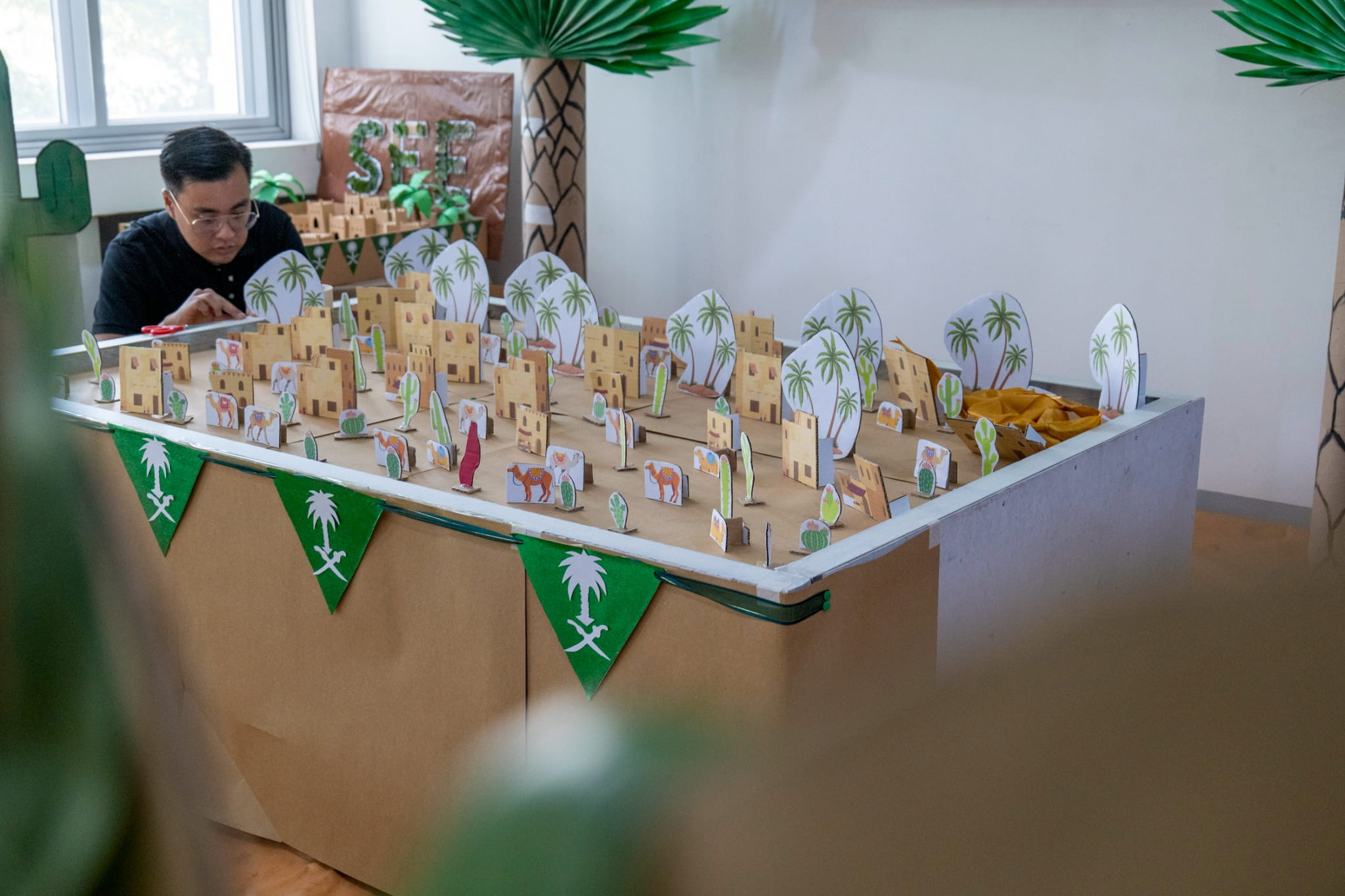 Parents work together behind the scenes to prepare their cultural booths. 