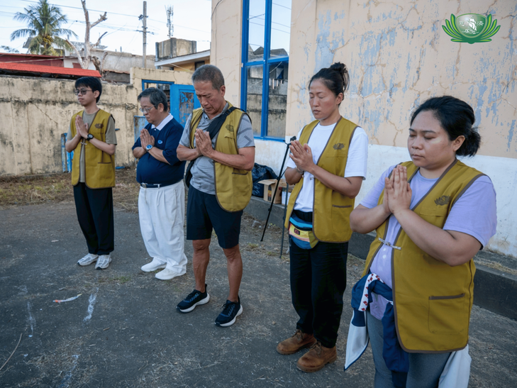 Students and volunteers pray for better days ahead following the sheer damage and loss caused by Super Typhoon Nando.