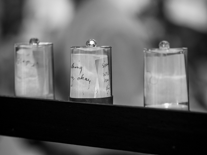 Guest wrote their personal wishes on a strip of paper that volunteers placed on a candle holder and kept on a shelf.【Photo by Daniel Lazar】