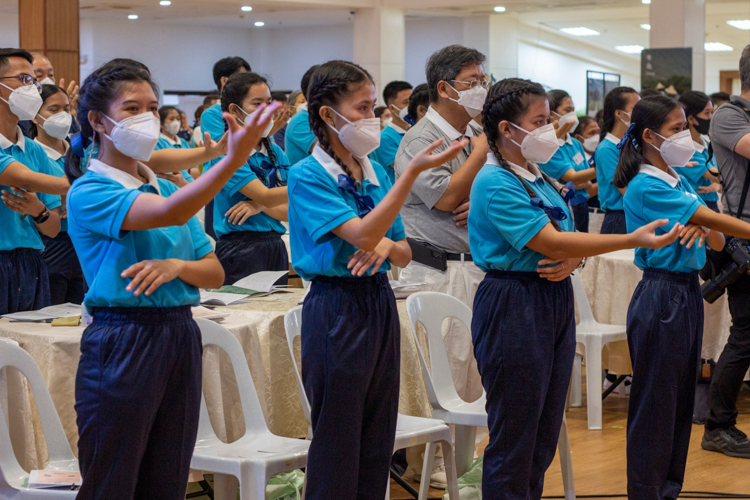 Scholars learn sign language for the camp song “A Life Powered By Love.”【Photo by Marella Saldonido】