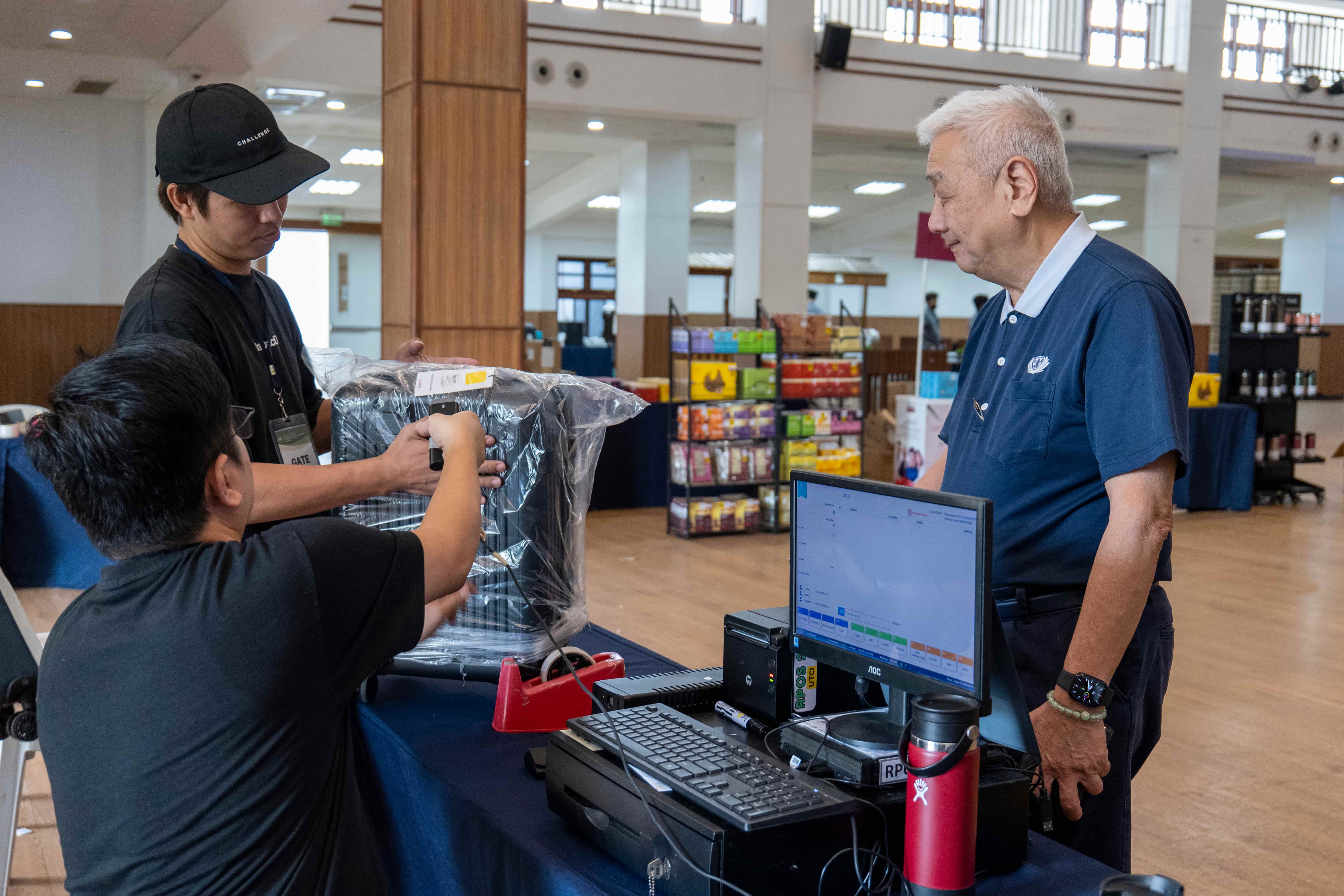 Tzu Chi Philippines CEO Henry Yunez leads the way as the very first customer on Day One of the sale.
