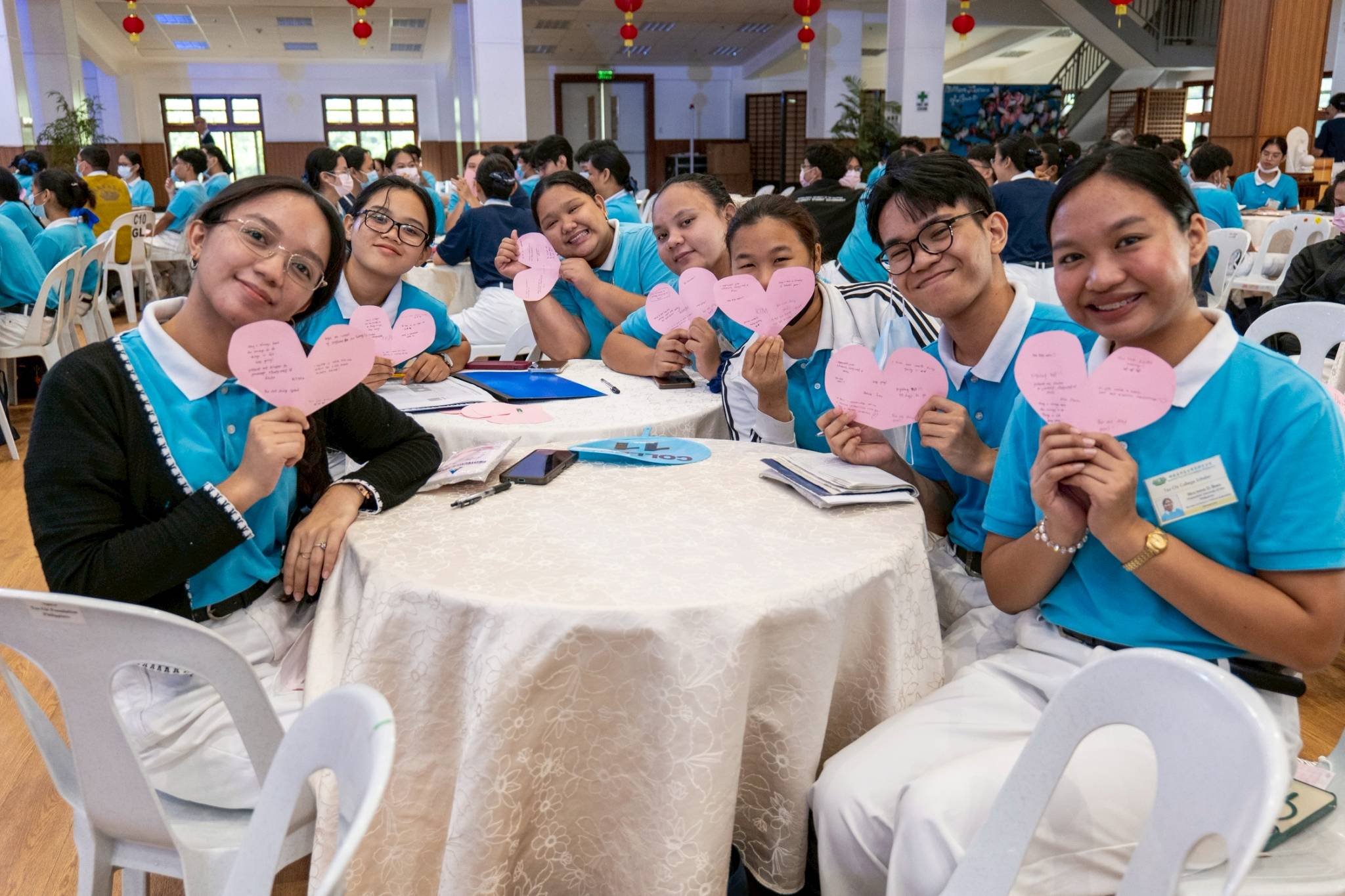 Scholars held up their paper hearts with messages written by their fellow scholars. 