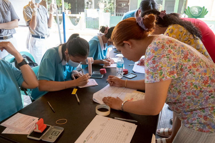 Beneficiaries sign up for the relief distribution, claiming their relief cards.