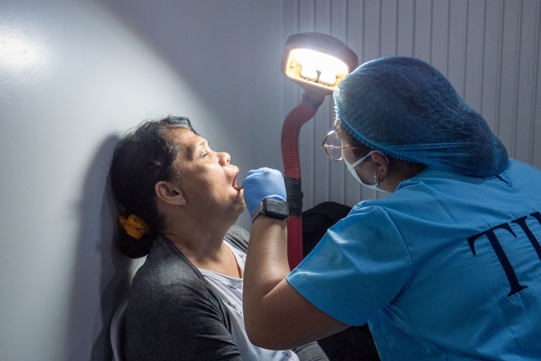 Jocelyn Garcia (left) gets a tooth extraction.
