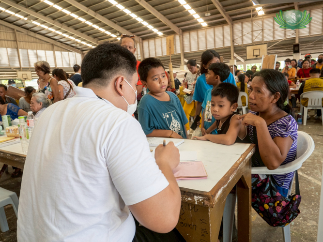 Mae Matabaran (right) had her two sons undergo checkups after claiming her relief stub.
