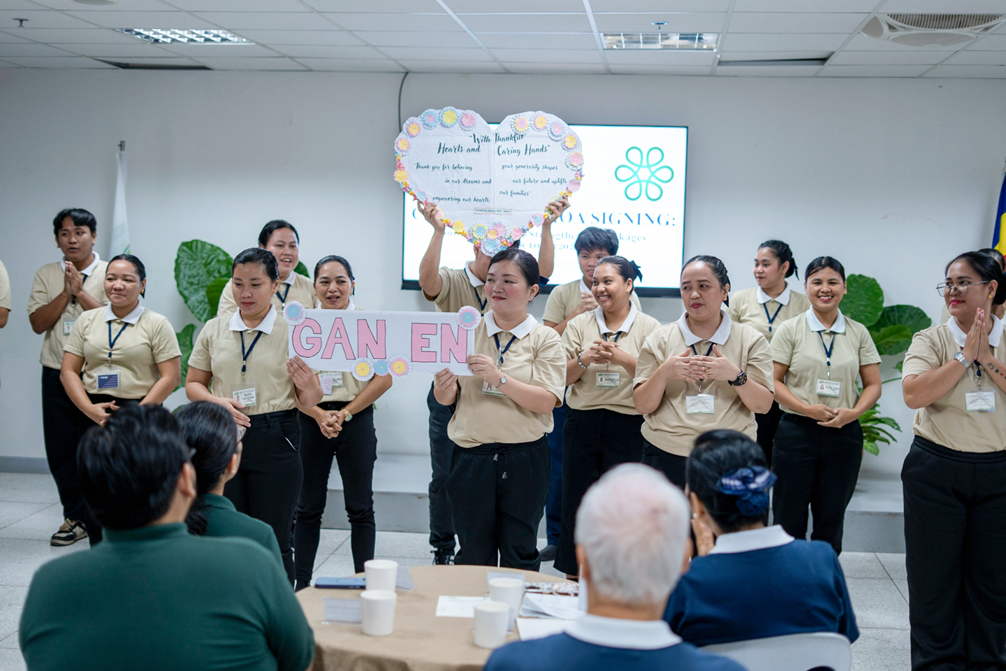 Caregiving scholars perform a sign-language tribute in appreciation of the two foundations’ generosity and support.