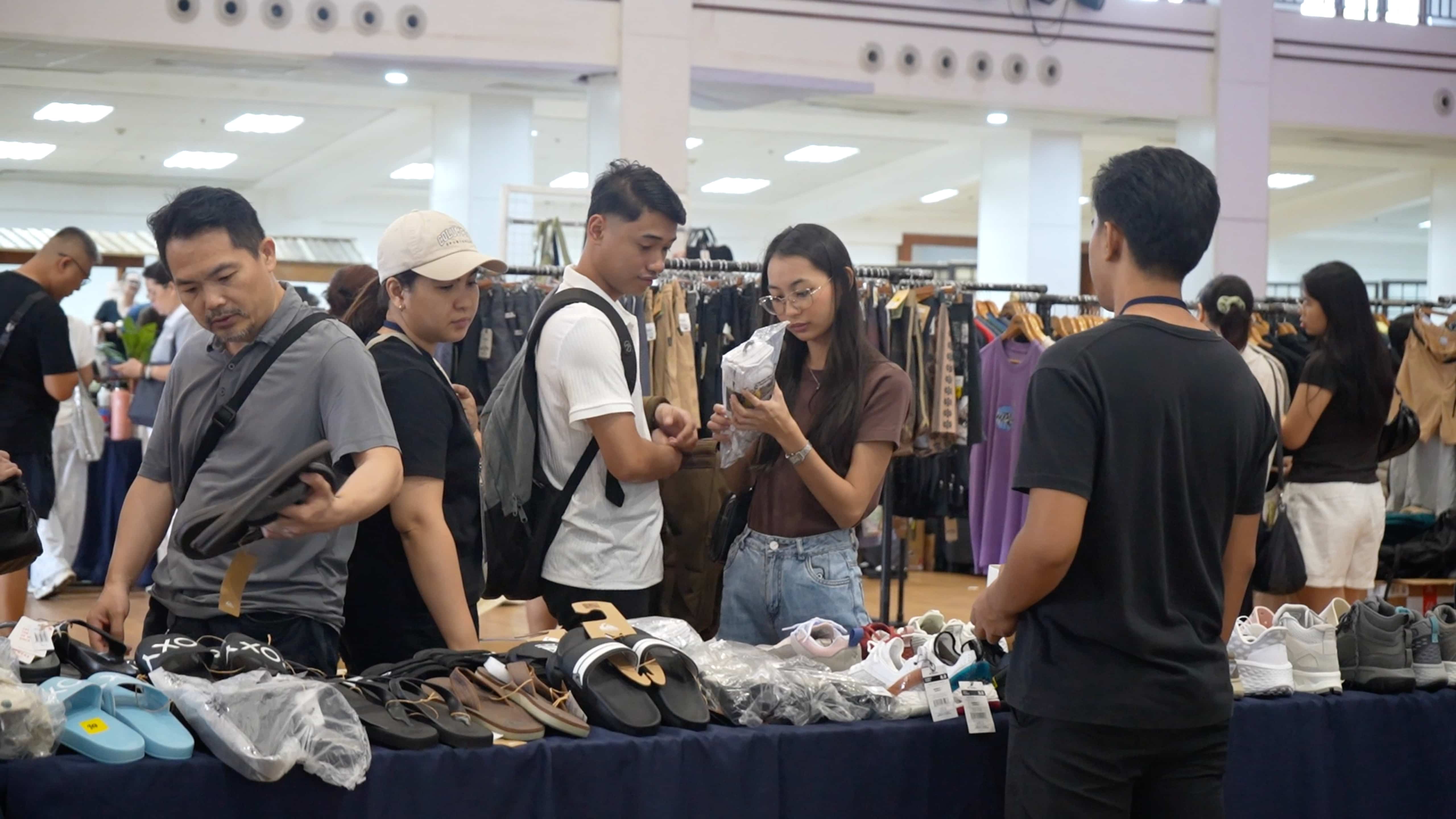 Shopper Maria Jenine Enriquez (in brown, second from right) browses through a wide selection of shoes and sandals.