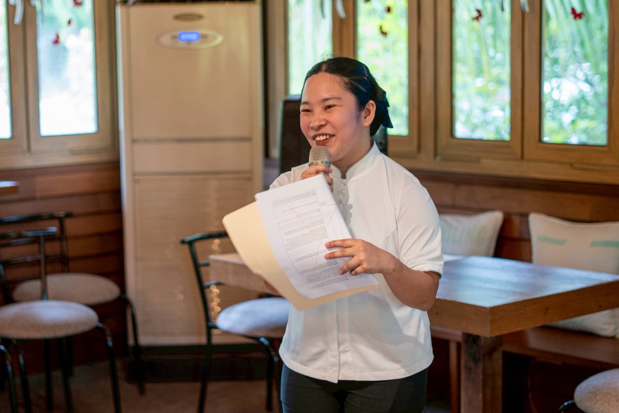 Caregiving Batch 10 scholar Esmeralda Daganasol hosts the morning program at the Tzu Chi Café. 