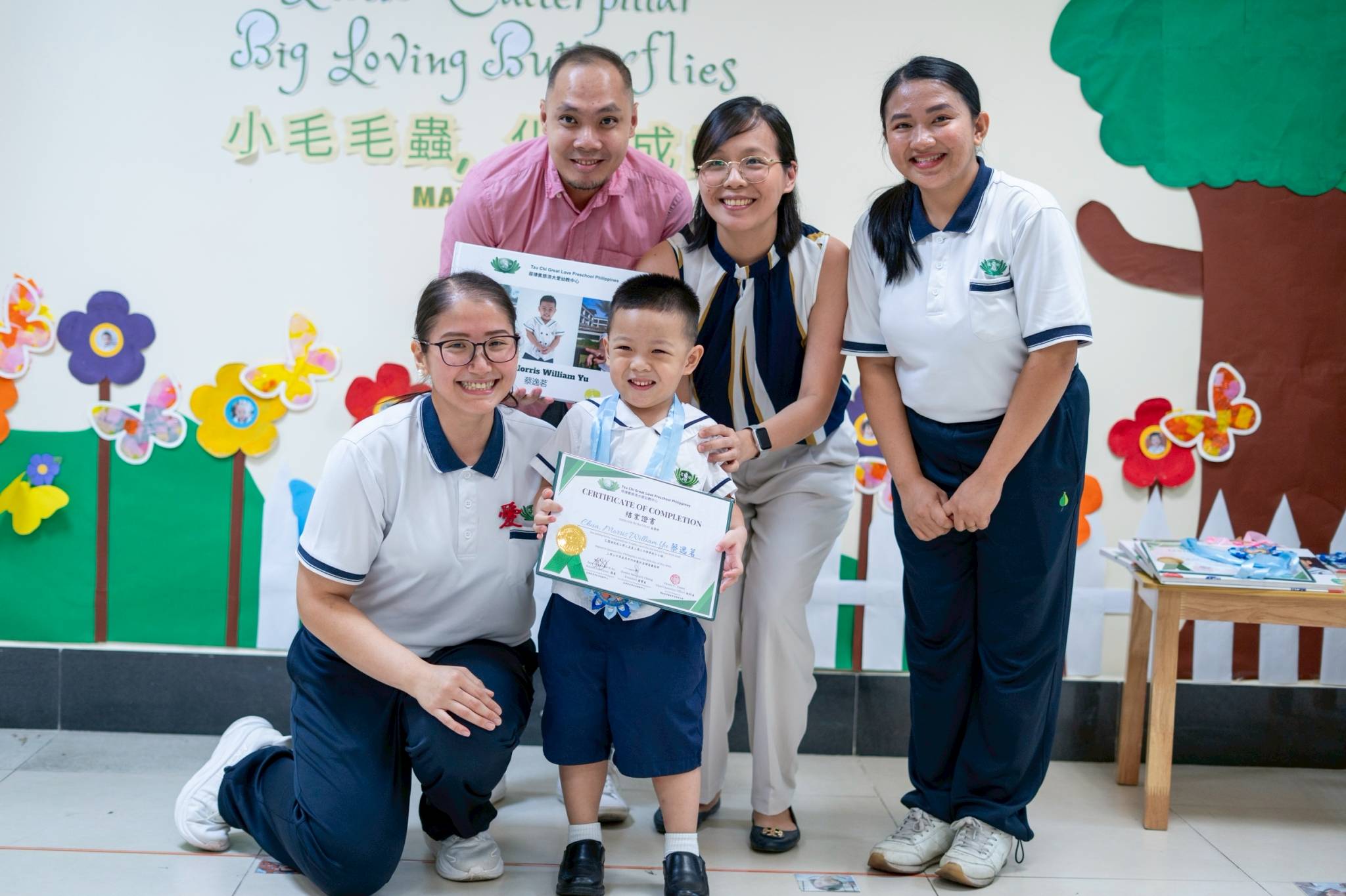 Parents Philip and Stephanie Camille Chua smile as their son Morris receives his awards: Big Kid Growth and Groovy Dancer. 